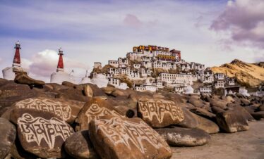 a beautiful building near a rocky shore